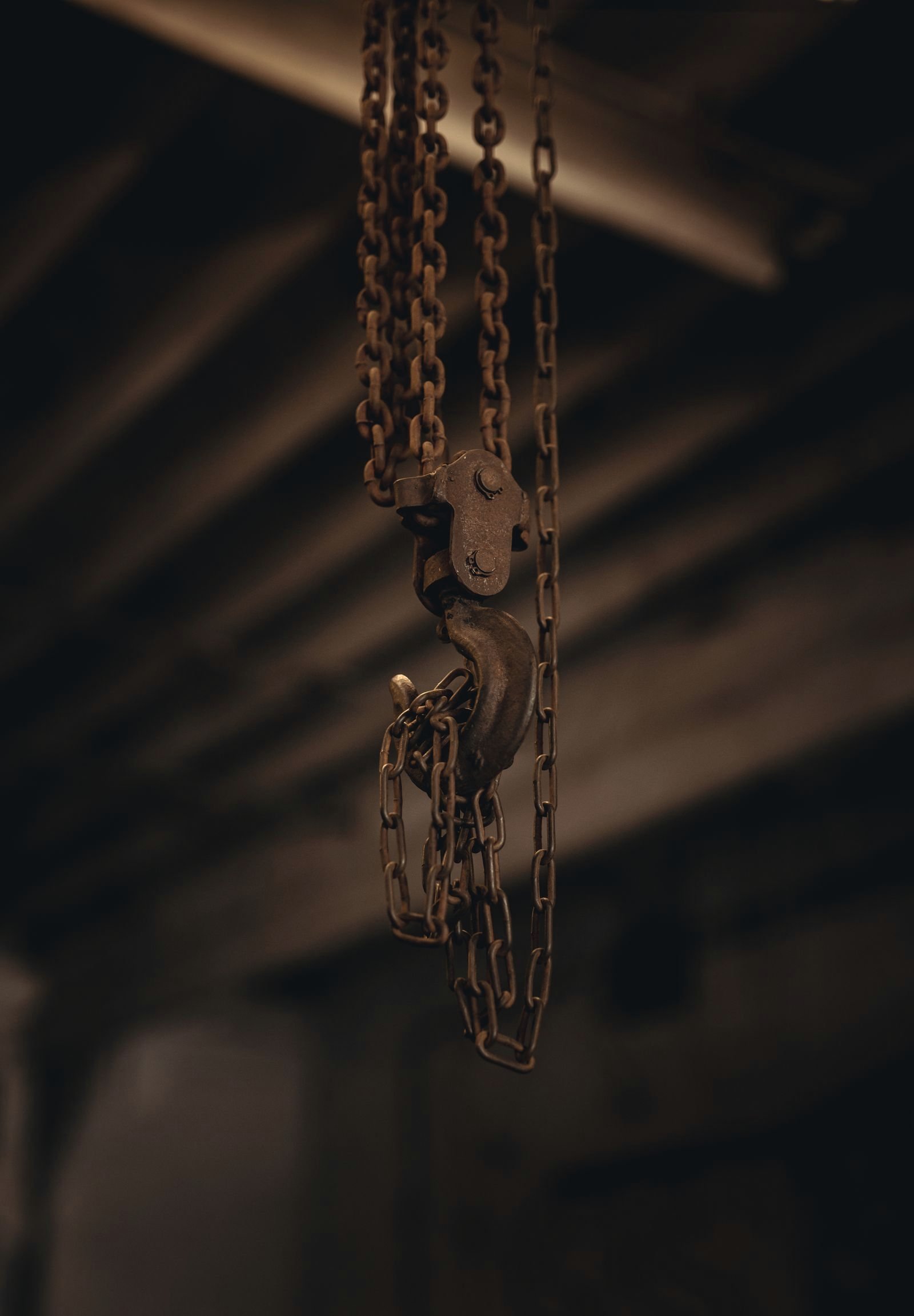 Hook and chain hanging in a dark workshop